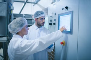 Food technicians working together in a food processing plant