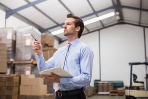 Side view of manager holding clipboard in the warehouse-2